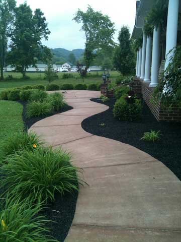 black tire mulch used in a flower bed on the side of a house