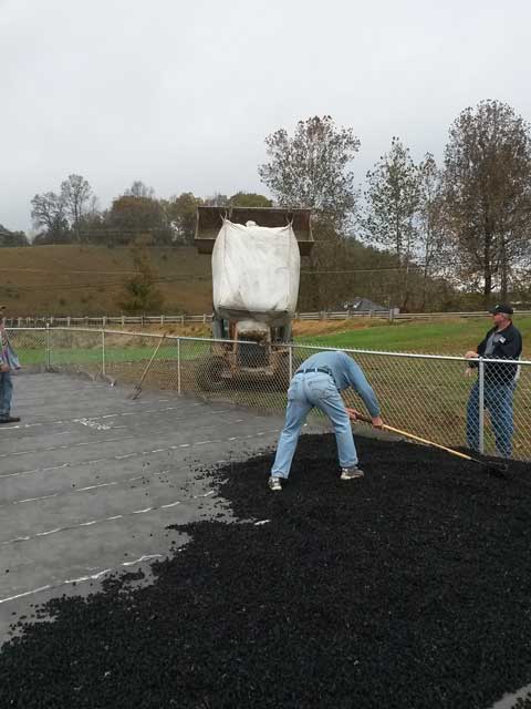 black tire mulch used in a flower bed on the side of a house